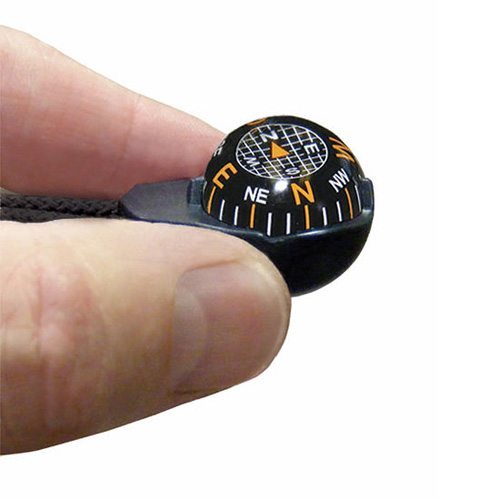 ZiprComp tiny ball compass shown with hand for scale